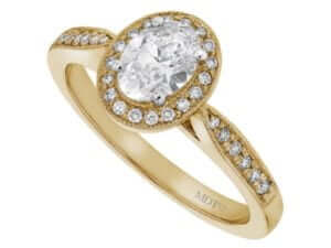 A stunning Grain Set Oval Diamond Halo Engagement Ring C1018, delicately crafted in yellow gold.