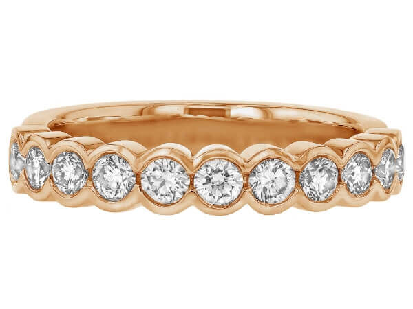 A stunning 18k rose gold wedding ring, featuring a half bezel set of round diamonds in an eternal band.