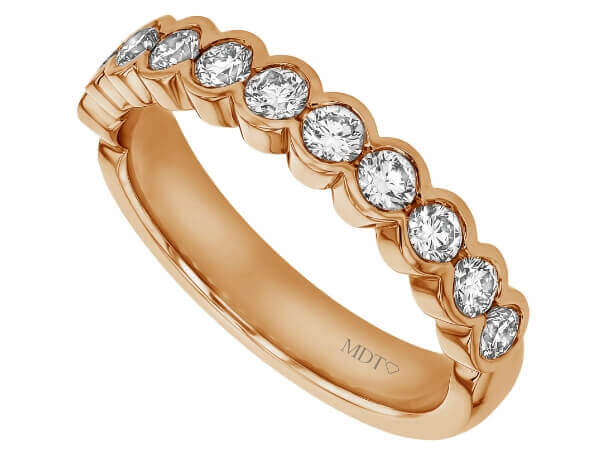 A half bezel set round diamond wedding ring with a rose gold band.