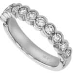 A half bezel set white gold band with round diamonds, perfect as a wedding ring.
