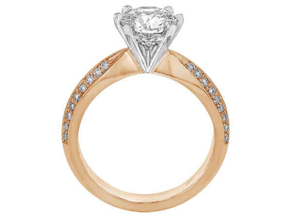 A diamond engagement ring with a round diamond in the center, delicately held by claw prongs, in a stunning rose gold setting.