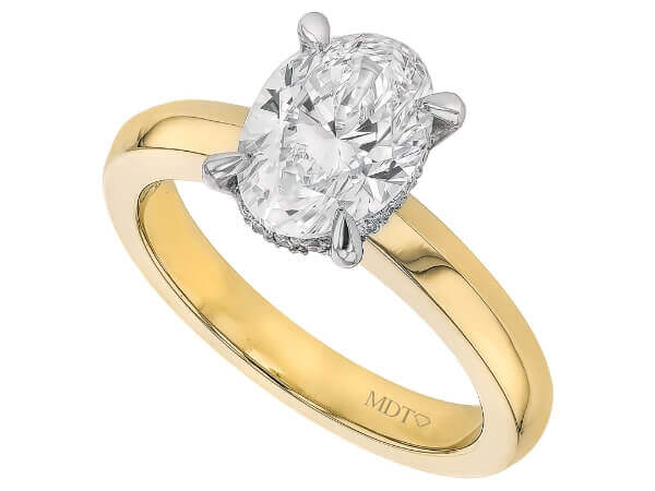 A stunning oval cut diamond engagement ring elegantly crafted in yellow gold.