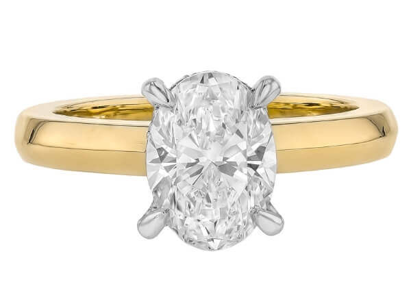 A stunning oval cut diamond engagement ring in yellow gold, featuring a hidden halo for added brilliance.