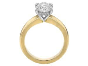 A yellow gold engagement ring showcasing an oval diamond.