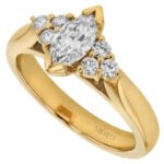 Marquise trilogy diamond engagement ring in yellow gold.