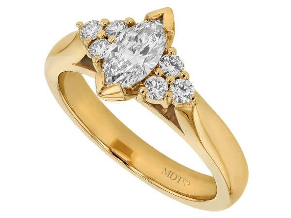 Marquise trilogy diamond engagement ring in yellow gold.