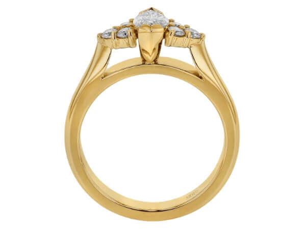 A marquise diamond trilogy engagement ring in yellow gold.