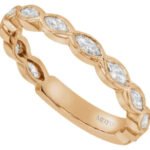 A C1069, 18ct rose gold band adorned with marquise diamonds.
