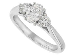 A trilogy engagement ring featuring an oval diamond set in 18ct white gold.
