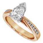 A pear-shaped diamond engagement ring in rose gold with a channel-set diamond band.