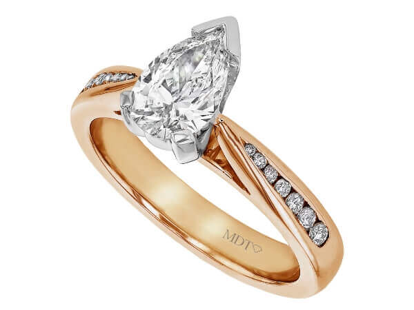 A pear-shaped diamond engagement ring in rose gold with a channel-set diamond band.