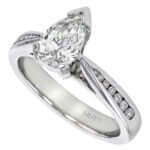 Pear shaped diamond engagement ring with channel set diamond band.