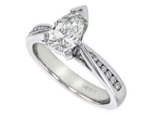 Pear shaped diamond engagement ring with channel set diamond band.