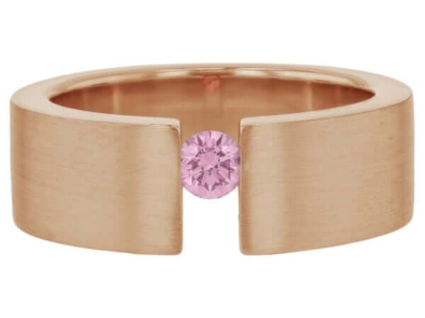 A tension set rose gold ring with a pink sapphire.