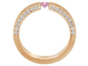 A pink diamond and sapphire tension set ring in rose gold.