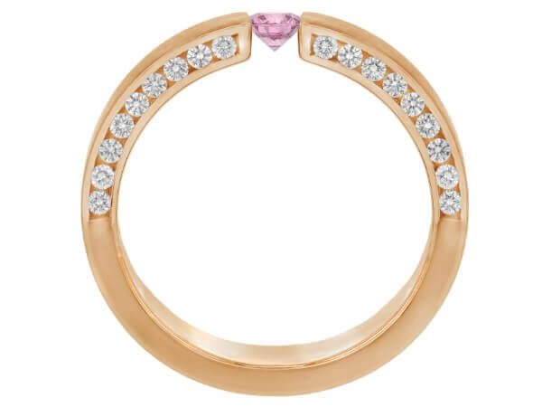A pink diamond and sapphire tension set ring in rose gold.