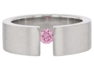 A Pink Diamond Tension Set Ring with Diamonds on the Face of the Band C827 with a pink sapphire in the middle.