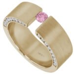 A yellow gold tension set ring featuring a radiant pink sapphire and sparkling diamonds.