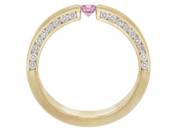 A pink sapphire and diamond tension set ring in yellow gold.