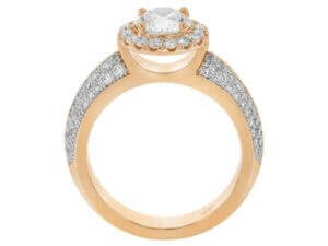 A stunning Halo Engagement Ring set in rose gold, featuring a dazzling Round Diamond surrounded by shimmering diamonds on a Pave Diamond Band.