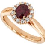 An oval ruby and diamond engagement ring in rose gold.