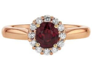 A stunning oval garnet engagement ring in rose gold, with a diamond halo.