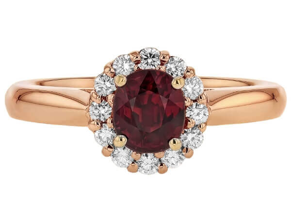 A stunning oval garnet engagement ring in rose gold, with a diamond halo.