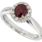 An elegant oval ruby and diamond halo engagement ring.