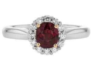 A stunning oval ruby engagement ring adorned with a sparkling diamond halo, set in elegant white gold.