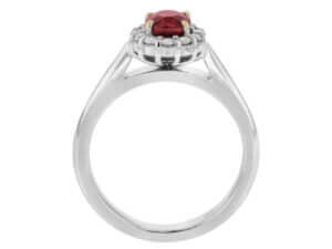An engagement ring with an oval ruby stone surrounded by a diamond halo.