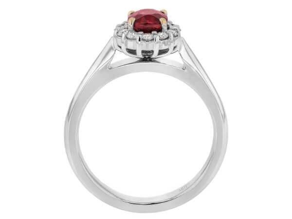 An engagement ring with an oval ruby stone surrounded by a diamond halo.