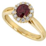 An elegant Oval Ruby Engagement Ring with Diamond Halo C1215 with a stunning oval ruby stone surrounded by a diamond halo.