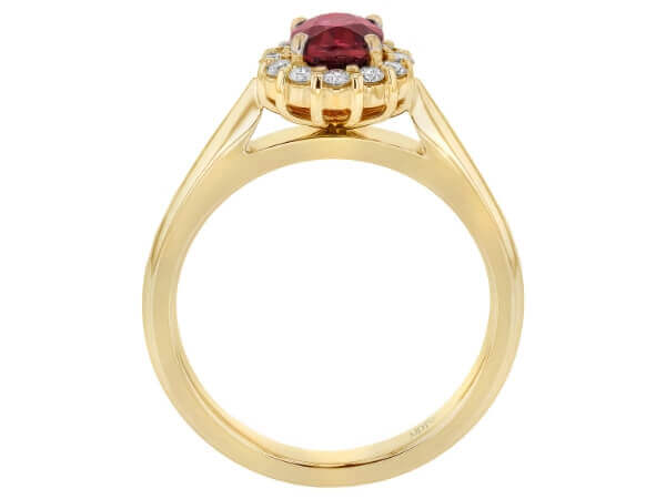 This Oval Ruby Engagement Ring with Diamond Halo C1215 features an oval ruby stone surrounded by a diamond halo.