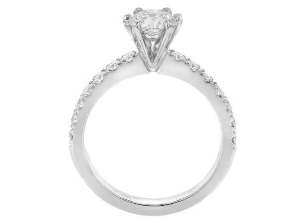 A round brilliant cut diamond engagement ring in white gold featuring a six claw setting -side view