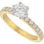 A diamond engagement ring with a round diamond in the center, featuring a yellow gold band.