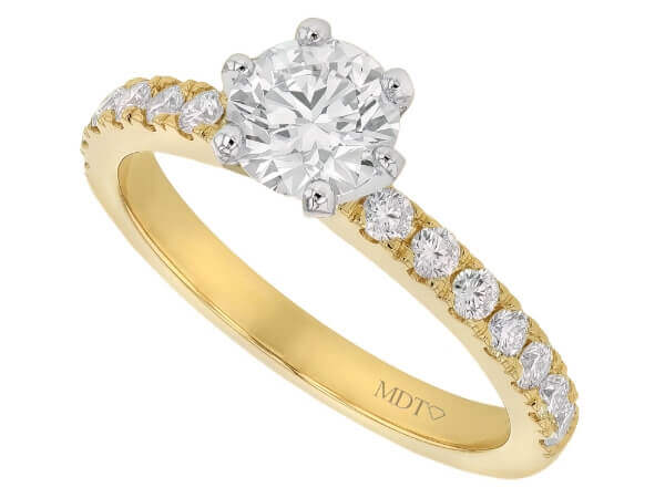 A diamond engagement ring with a round diamond in the center, featuring a yellow gold band.