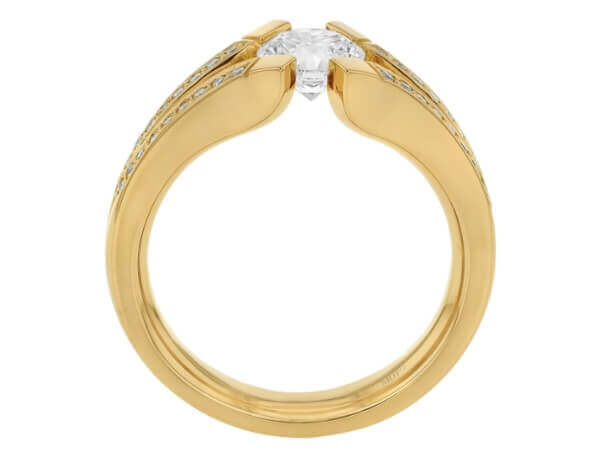 A Diamond Tension Set Ring in Yellow Gold featuring an Oval Cut Diamond.