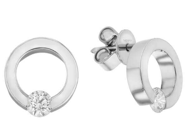 A pair of white Gold Tension Set .15ct Diamond Earrings C1101. tension set diamond in the center.