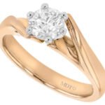 An 18ct rose gold engagement ring with a round cut diamond, the perfect diamond engagement ring option combining elegance and luxury in its twiste band solitaire design.