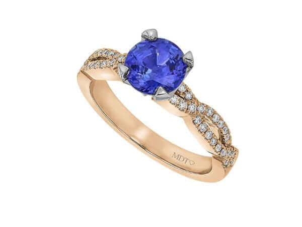 Gold ring with blue sapphire and diamonds.