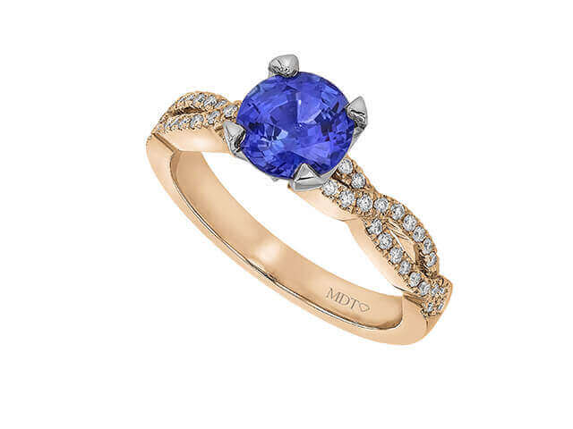 Gold ring with blue sapphire and diamonds.