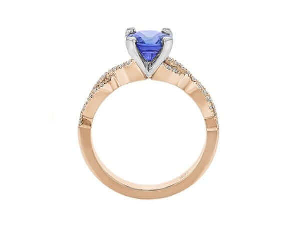Gold ring with heart-shaped blue gemstone.