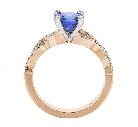 Gold ring with heart-shaped blue gemstone.