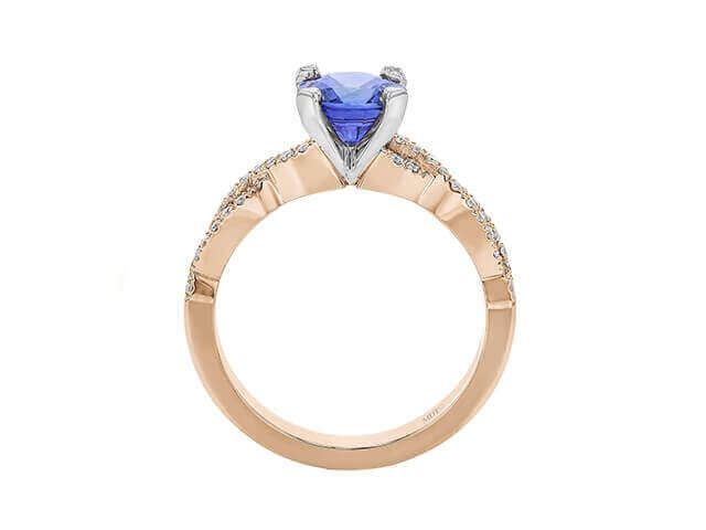 Gold ring with heart-shaped blue gemstone.