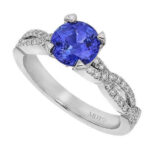 Blue sapphire diamond ring on white background.