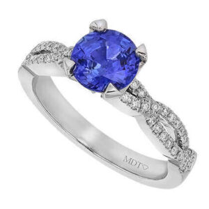 Blue sapphire diamond ring on white background.
