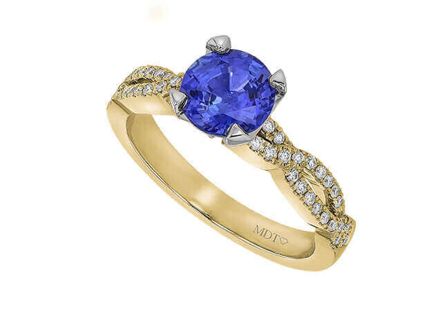 Gold ring with blue sapphire and diamonds.