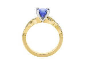 Gold ring with heart-shaped blue gemstone.