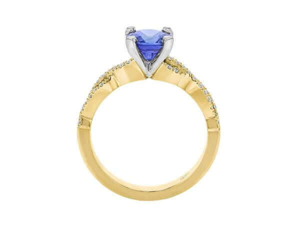 Gold ring with heart-shaped blue gemstone.