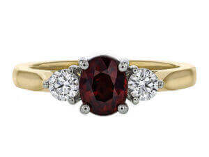 yellow Gold ring with oval ruby centre and 2 round white diamonds . top view